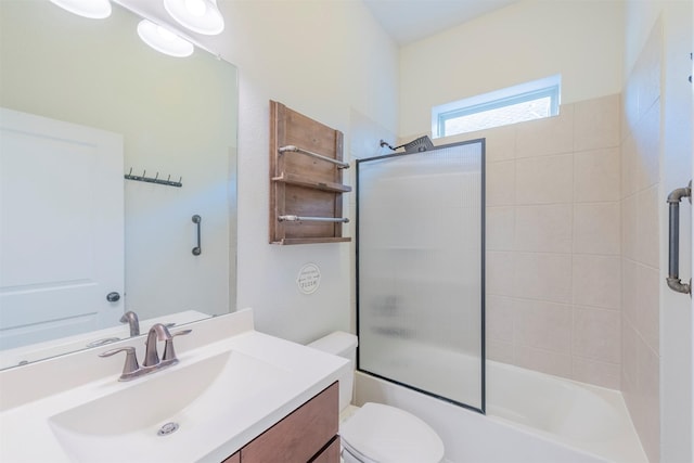 full bathroom featuring vanity, bath / shower combo with glass door, and toilet