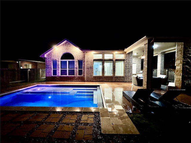 pool at night with a patio