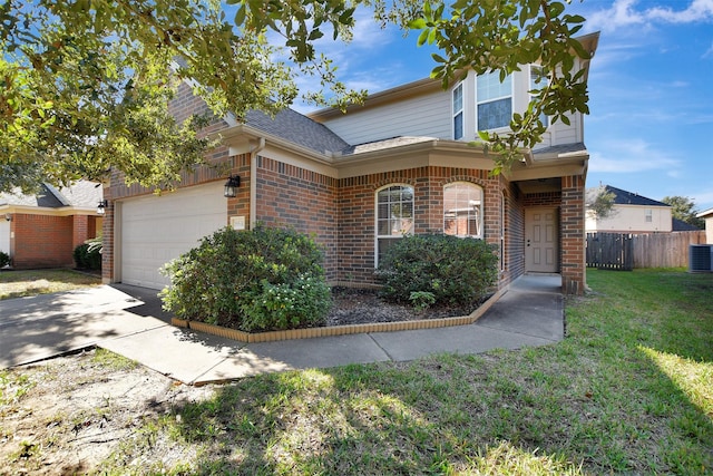 view of front facade featuring a front lawn, central AC unit, and a garage