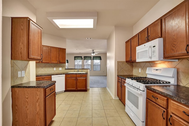 kitchen featuring ceiling fan, sink, white appliances, decorative backsplash, and light tile patterned floors