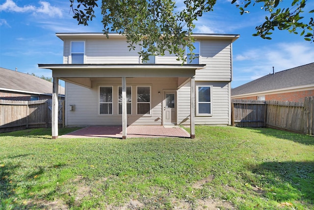 back of property featuring a lawn and a patio area