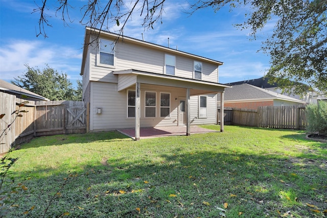 rear view of house with a patio and a lawn