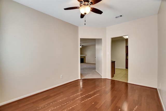 unfurnished room with light hardwood / wood-style flooring and ceiling fan