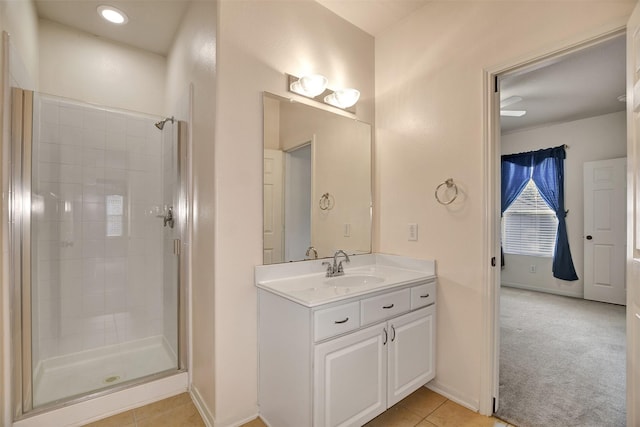 bathroom with tile patterned flooring, vanity, and walk in shower