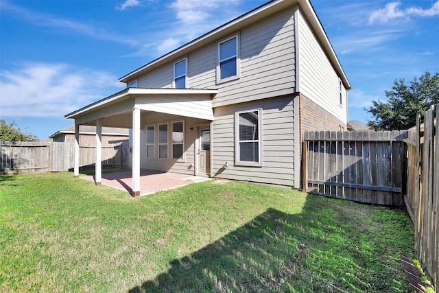 back of property featuring a patio area and a yard