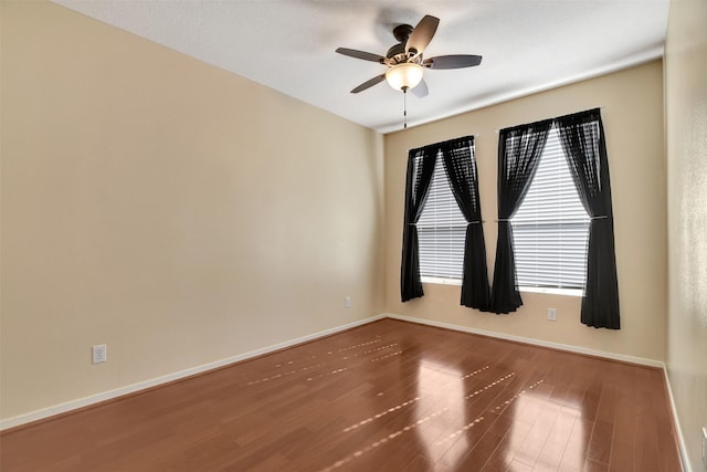 unfurnished room with ceiling fan and hardwood / wood-style flooring