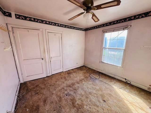 unfurnished bedroom featuring ceiling fan