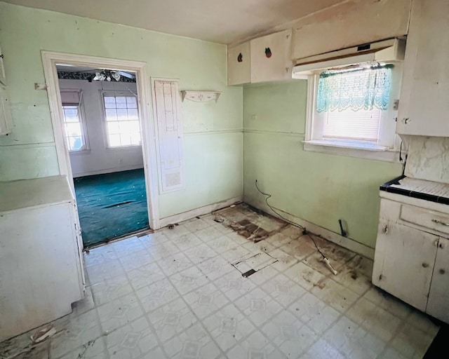 kitchen with white cabinets and tile counters