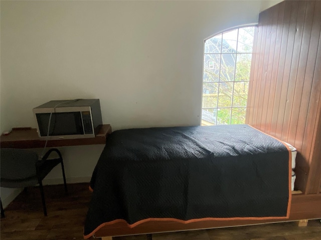 bedroom featuring wooden walls