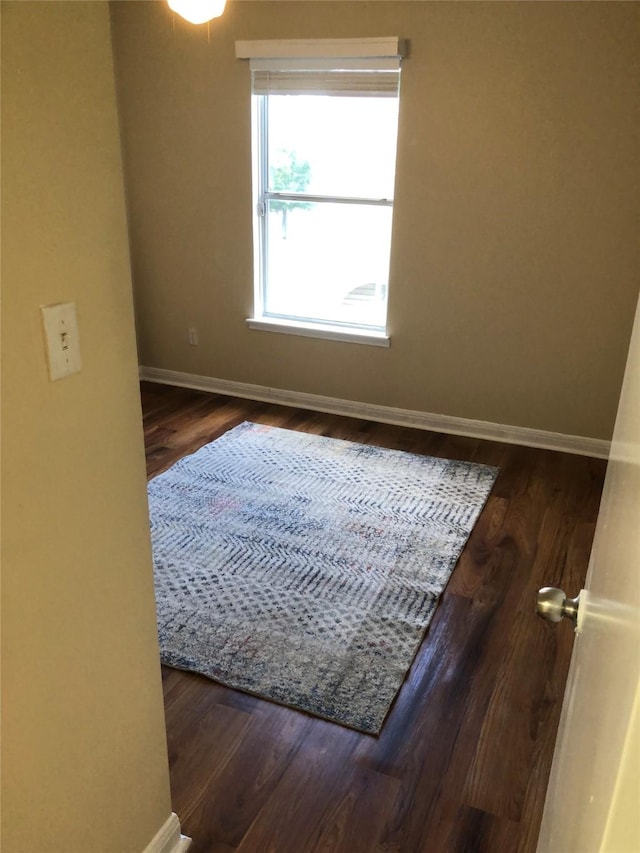 spare room with dark wood-type flooring