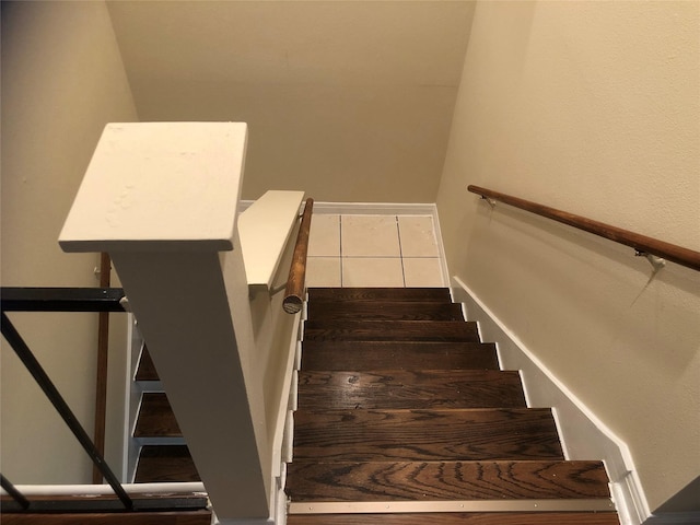 staircase featuring tile patterned flooring