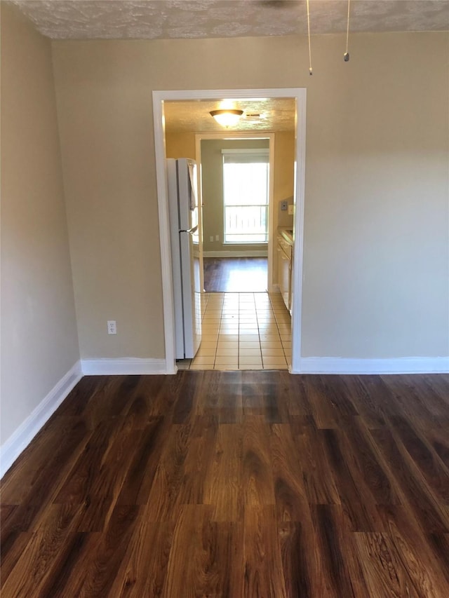 hall featuring hardwood / wood-style flooring and a textured ceiling