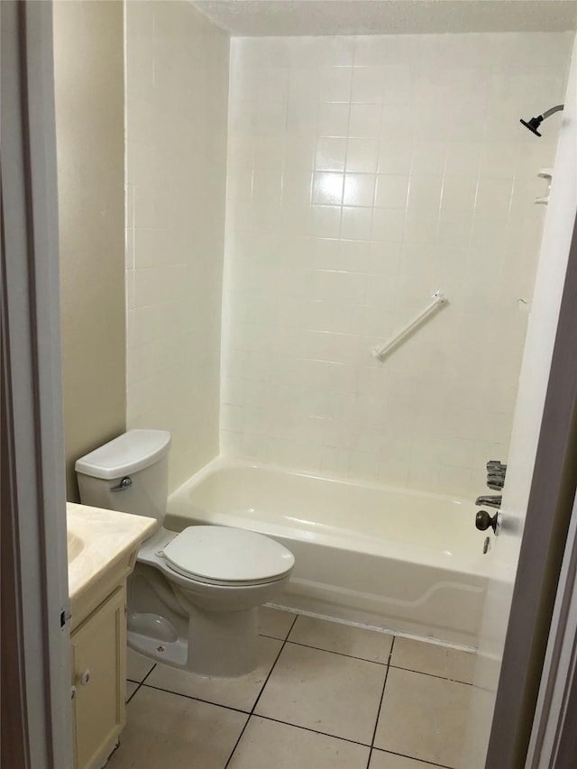 full bathroom with tile patterned floors, vanity, toilet, and tiled shower / bath combo