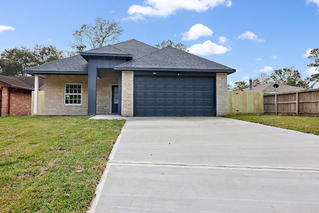 view of front of property featuring a front lawn and a garage