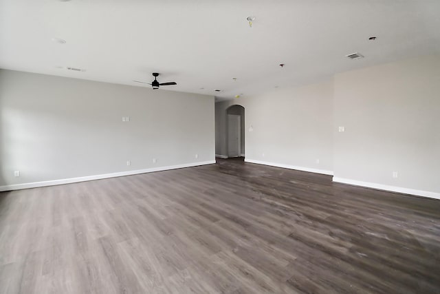 empty room featuring dark hardwood / wood-style floors and ceiling fan