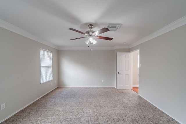 unfurnished room featuring ceiling fan, crown molding, and light carpet