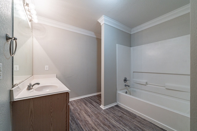 bathroom featuring shower / bath combination, vanity, a textured ceiling, crown molding, and hardwood / wood-style flooring