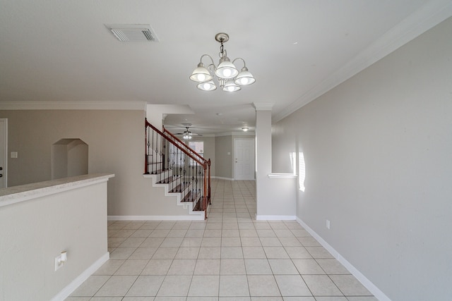 interior space featuring ceiling fan with notable chandelier, tile patterned floors, and ornamental molding