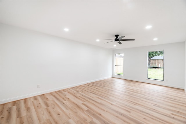 unfurnished room with light wood-type flooring and ceiling fan