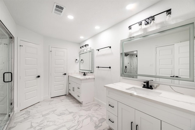 bathroom featuring vanity and a shower with shower door