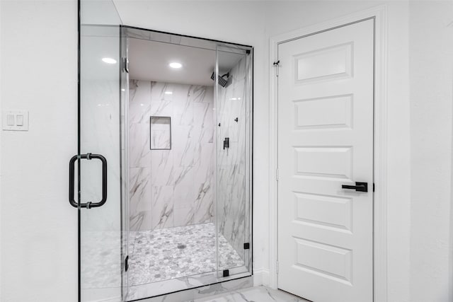 bathroom with a shower with door