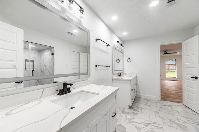 bathroom with vanity, a shower with door, ceiling fan, a textured ceiling, and wood-type flooring