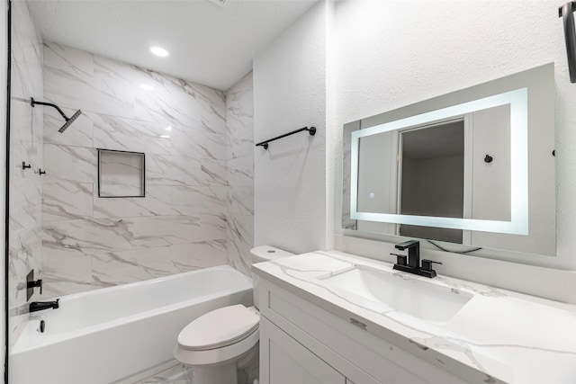 full bathroom featuring vanity, toilet, and tiled shower / bath