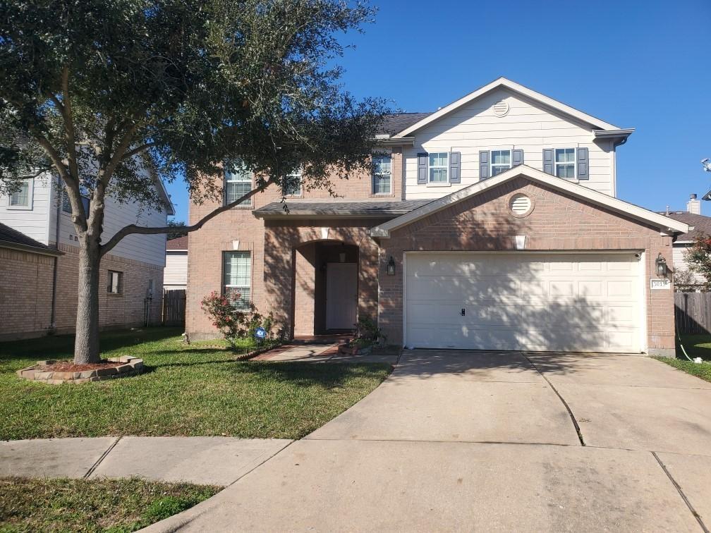 view of front property with a garage and a front yard