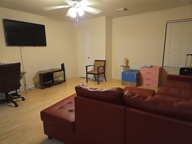 living room with hardwood / wood-style floors and ceiling fan