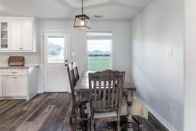 dining space featuring dark wood-type flooring