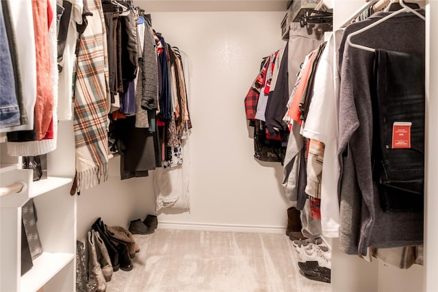 walk in closet featuring carpet flooring