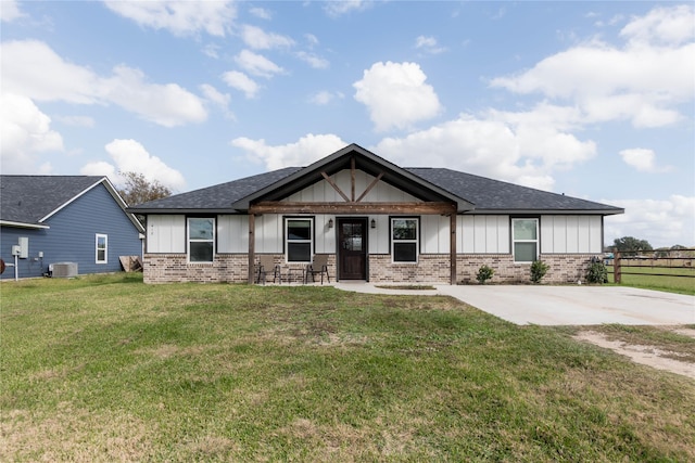 craftsman inspired home with central AC unit and a front yard