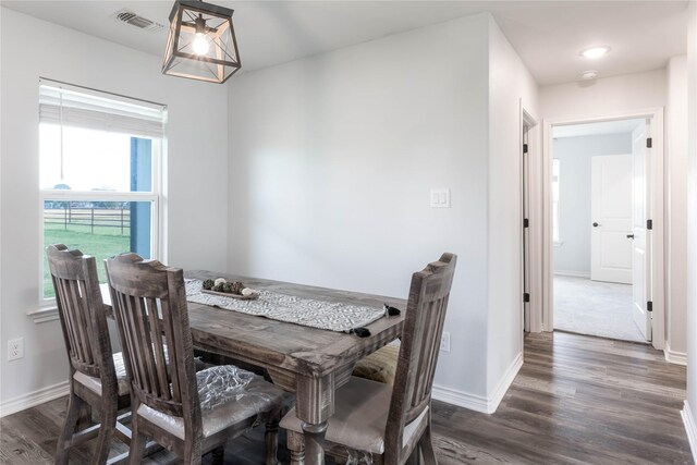 dining space with dark wood-type flooring