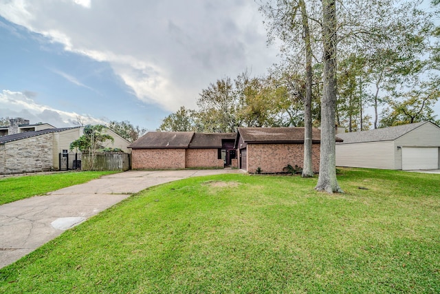 view of front of house featuring a front yard and a garage