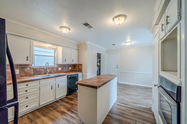 kitchen with white cabinets, dishwasher, oven, and dark wood-type flooring