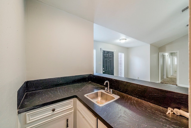 bathroom with sink and lofted ceiling