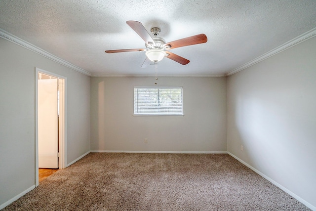 carpeted empty room featuring ceiling fan, ornamental molding, and a textured ceiling