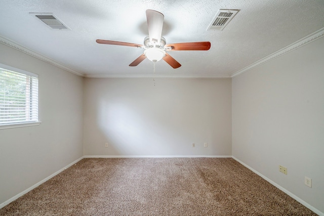 carpeted spare room featuring crown molding and a textured ceiling