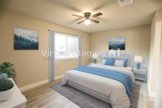 bedroom featuring a textured ceiling, hardwood / wood-style flooring, and ceiling fan