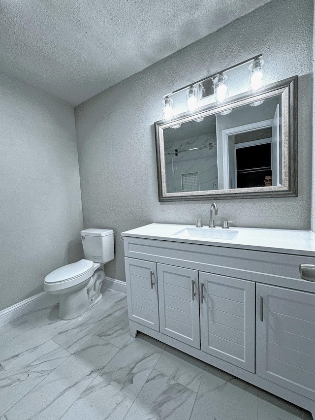 bathroom featuring vanity, a shower, a textured ceiling, and toilet