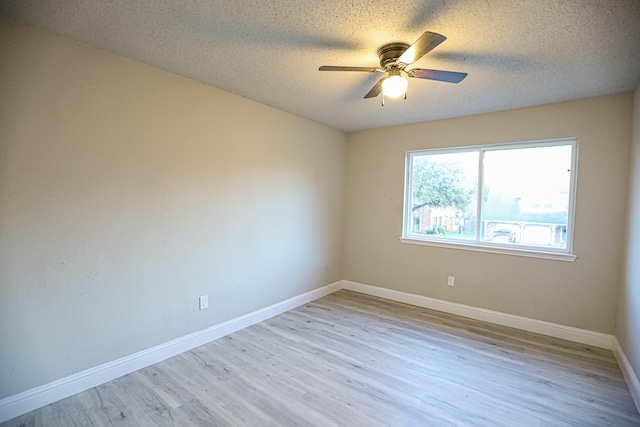 spare room featuring ceiling fan, a textured ceiling, and light hardwood / wood-style flooring