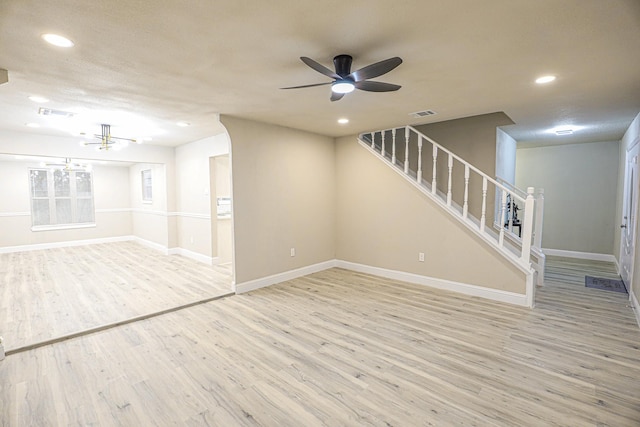 unfurnished living room with ceiling fan and light hardwood / wood-style flooring