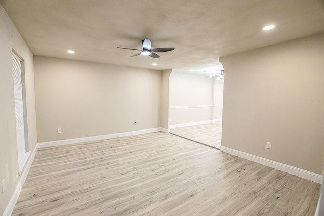 unfurnished room with ceiling fan and light hardwood / wood-style floors