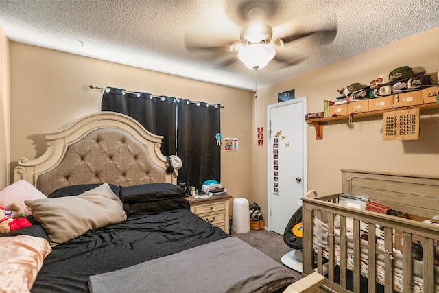 carpeted bedroom with a textured ceiling and ceiling fan