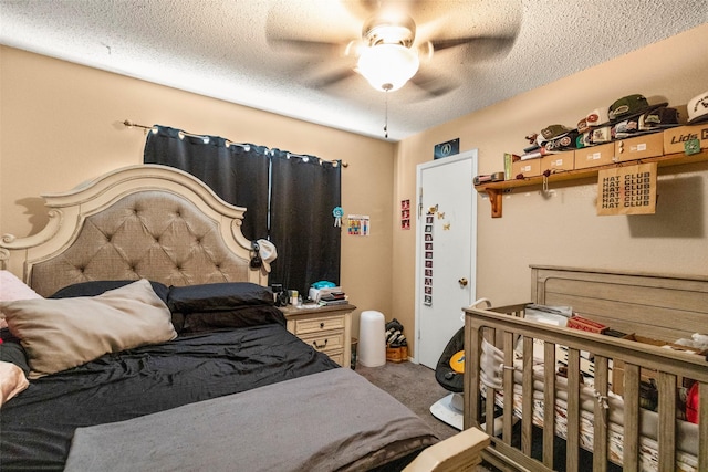 bedroom with carpet, a textured ceiling, and ceiling fan