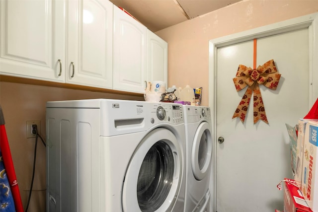 laundry area featuring cabinets and washing machine and clothes dryer