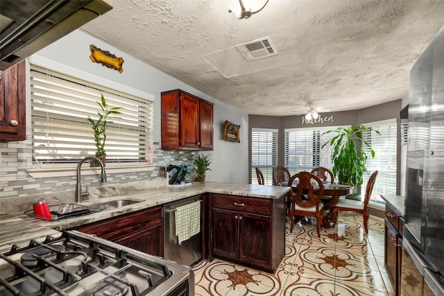 kitchen with ceiling fan, stainless steel appliances, tasteful backsplash, kitchen peninsula, and light tile patterned floors