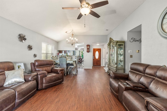 living room featuring lofted ceiling, ceiling fan with notable chandelier, and dark hardwood / wood-style floors