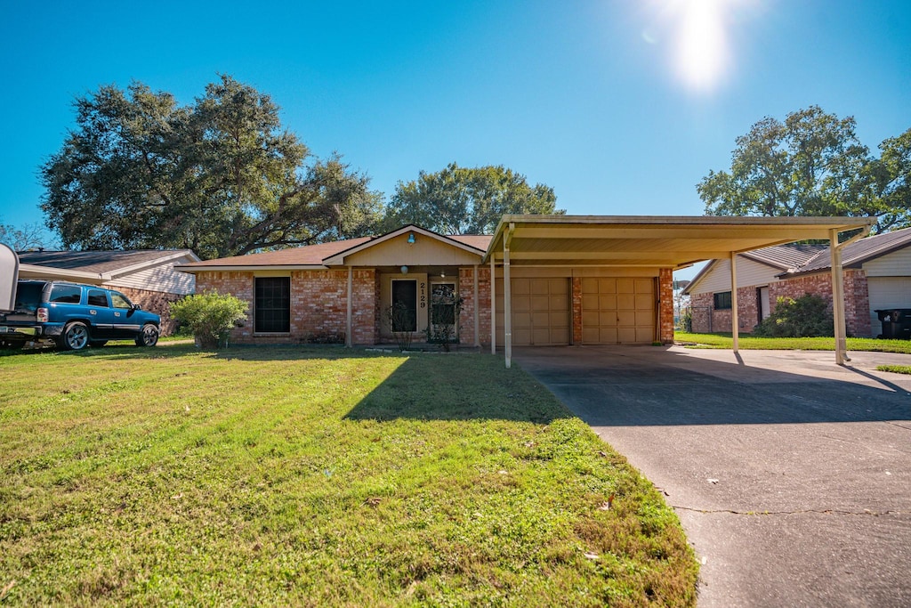 single story home featuring a front lawn and a carport