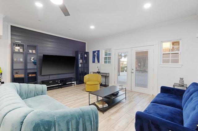 living room with french doors, light hardwood / wood-style flooring, ceiling fan, and ornamental molding